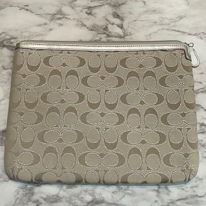 Khaki Coach clutch with pink satin lining